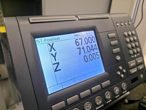 A close-up of Xyz coordinates displayed on a control panel in a manufacturing environment photo