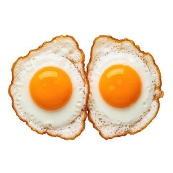 Two perfectly fried eggs with bright orange yolks and crispy edges, isolated on a white background photo