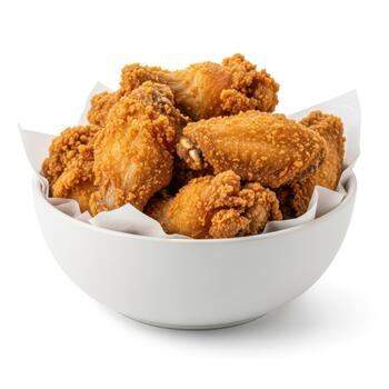 A generous bowl filled with crispy golden fried chicken wings, isolated on white background photo