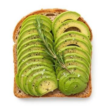 Avocado toast with rosemary and seasoning on a slice of whole wheat bread, isolated on white background photo