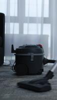 A Compact Vacuum Cleaner Positioned Near a Window with Soft Drapes, Showcasing Modern Design and Practicality for Efficient Home Cleaning Tasks video