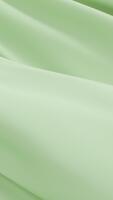 liscio verde tessuto agitando dolcemente la creazione di elegante minimo sfondo dolce pieghe fluente struttura chiarezza calma movimento delicato superficie purezza design armonia sereno astratto visivo morbidezza sfondo video
