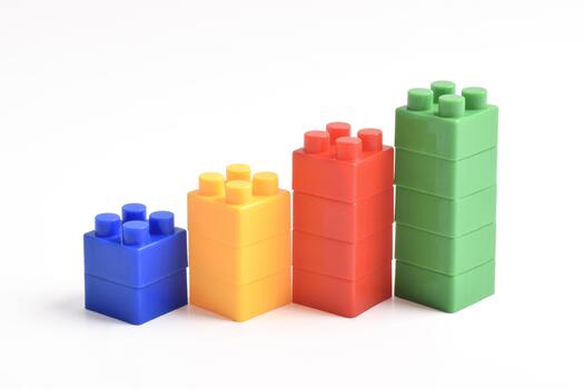 Four colorful building blocks arranged in ascending height on a white background. photo