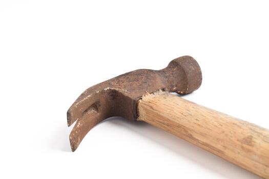 Close-up of a rusty claw hammer with a broken wooden handle on a white background. photo
