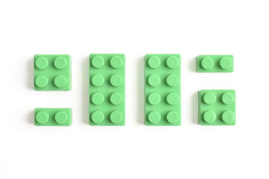 Bright Green Building Blocks Arranged in a Playful Pattern on White Background. photo