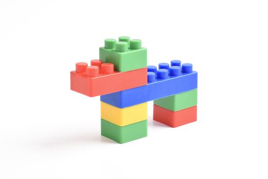 Colorful interlocking building blocks forming a simple structure on a white background. photo