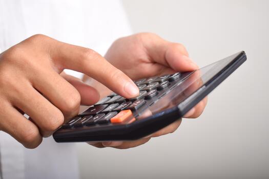 Close-up of hands using a calculator for financial calculations and accounting tasks. photo
