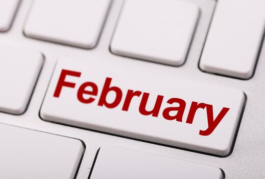 A close-up of a white computer keyboard key labeled February in red, symbolizing the second month of the year or digital scheduling. photo