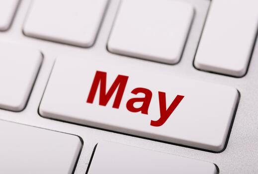A white keyboard with the word May in bold red letters on one key, symbolizing the calendar month in a digital concept style. photo