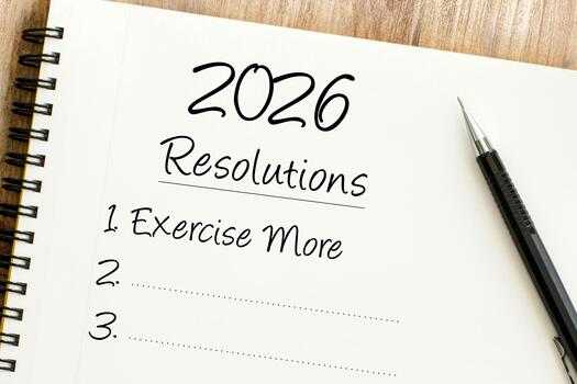 Setting new years objectives and personal commitments for a healthier, more productive 2026, displayed on a notepad with a pen photo