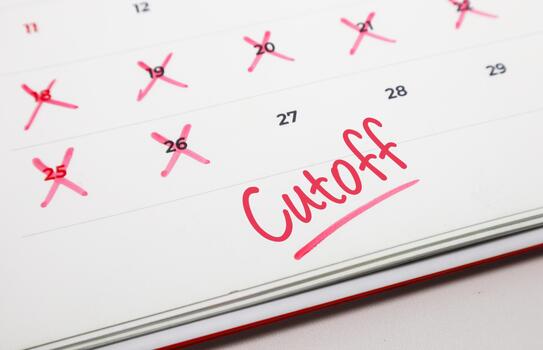 Calendar with red on dates and Cutoff written in red, symbolizing a critical deadline or time limit photo