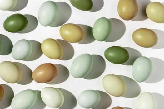 Easter eggs pattern, natural colored eggshell, hard Shadow at sunlight, light white background. Chicken eggs layout, top view, minimal flat lay, holiday food still life photo, trend pattern photo