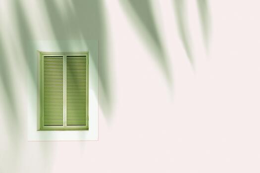 Retro Window with green closed Shutters Jalousie on beige background with palm leaf shadow, Window frame wood on outdoor wall building. Minimal design abstract. Summer time, travel concept copyspace photo