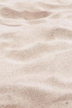 Beige pink Sand texture natural background. Close up waves pattern on sand dunes, light color, minimal nature vertical backdrop. Summer and travel, spa concept. Selective focus. photo