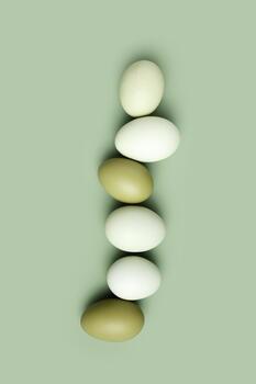 Top view natural easter Eggs green color with shadows on green background, minimal trend food pattern from organic Chicken egg with green gradient eggshells, Easter food celebration concept, photo