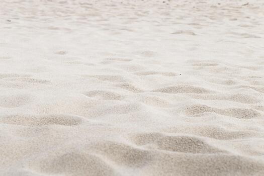 Beige Sand texture natural background. Close up waves pattern on sand dunes, light pastel color, minimal nature backdrop, beautiful beach. Summer and travel, spa and relax concept. Selective focus. photo