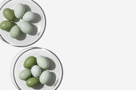 Easter eggs green gradient color on glass plate, shadow at sunlight, light background. Chicken eggs with colored eggshells, holiday food Easter, top view, trend aesthetic flat lay photo