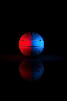 A spherical object with red and blue halves reflecting on a surface photo