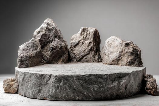 Natural stone podium with rough rocks for product display against a neutral gray background photo
