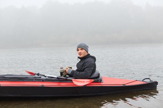 Kayaker on a foggy river photo