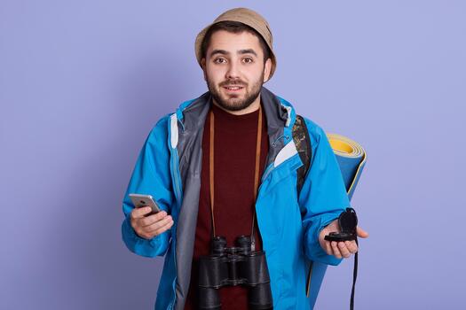 Hiker using phone with binoculars photo