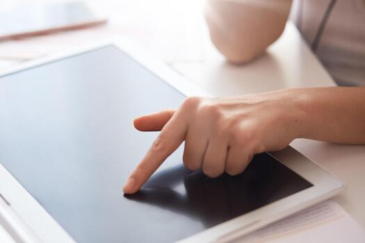 Touching a tablet screen with a finger photo