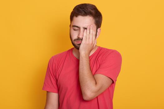 Frustrated man with yellow background photo