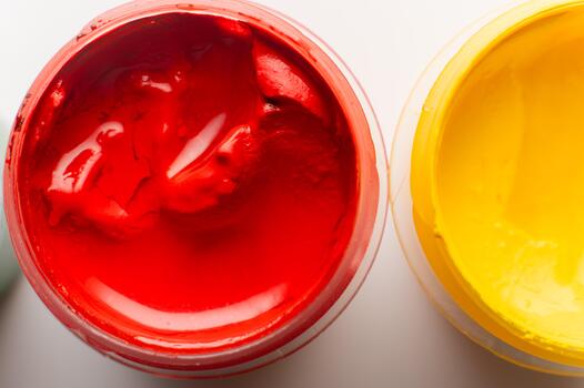 Close-up of a set of watercolor paints. Selective focus. Full frame close-up with small open jars of gouache on a white background photo