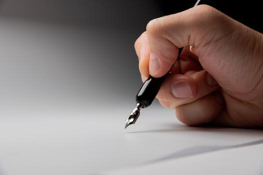 hand writes with a black pen on a clean white background with ample space for text. The hands masterfully practiced calligraphy on textured paper, surrounded by a serene atmosphere photo