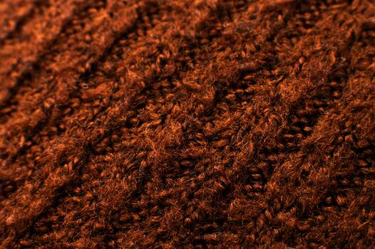 Background of knitting patterns. A close-up photo from above of the rows of a warm sweater made using the garter stitch technique and thick yarn. Fabric texture. woolen cloth