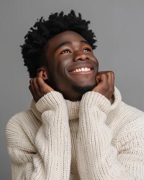 African-american Male Model Smiles Widely While Showcasing a Stylish Knit Sweater in a Simple Setting photo