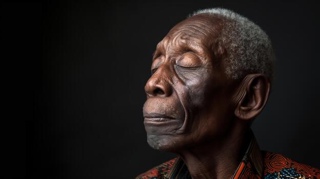 An African-american Man Sits Silently With Closed Eyes, Reflecting Feelings of Sadness in a Low-light Setting photo