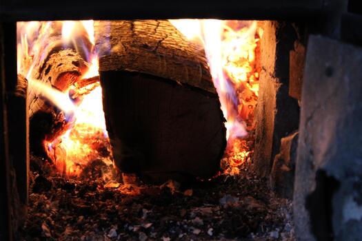 Warm glowing fireplace flames create a cozy atmosphere in a rustic setting during winter evenings photo