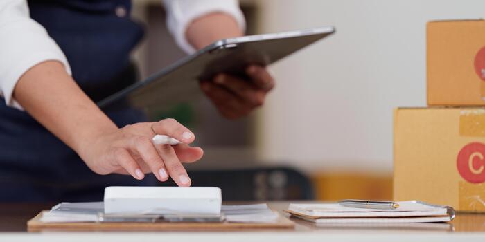 Efficiency. Individual managing tasks with tablet and calculator in a modern workspace. photo