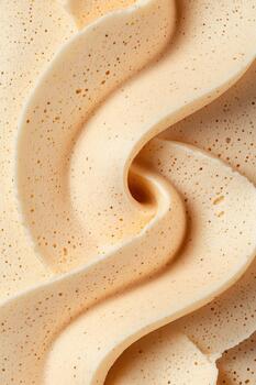 Smooth Creamy Swirl Close Up. Light Tan Dessert Frosting Texture. Gluten free low carb ingredient abstract design element. photo