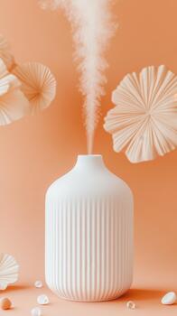 White diffuser releases mist near decorative paper fans and smooth stones against an orange background promoting relaxation and home spa experiences. photo