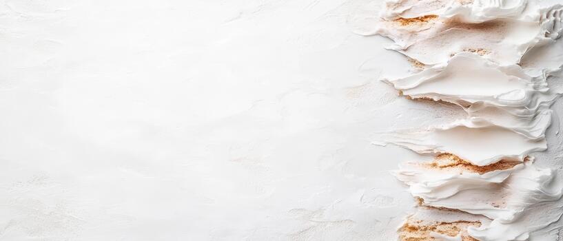 White cream strokes with gold dust accents on a textured background photo