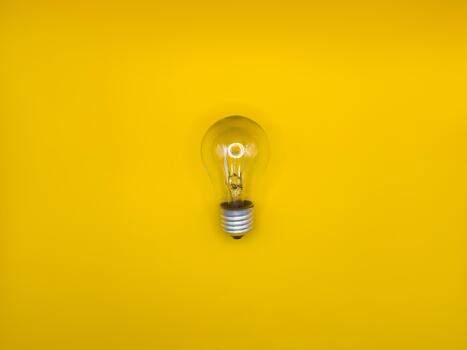 Tungsten light bulb lamp. Non working light bulb broken light Concept of light and dark, idea, electricity copy space, flay lay, top view yellow background. photo