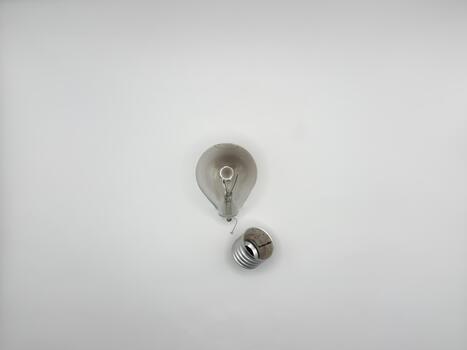 Tungsten light bulb lamp. Non-working light bulb, broken light bulb. Concept of light and dark, idea, electricity copy space, flay lay, top view photo