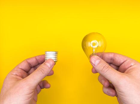 Tungsten light bulb lamp. Non-working light bulb, broken light bulb. Concept of light and dark, idea, electricity yellow background. photo