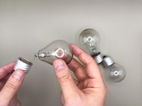 Tungsten light bulb lamp. Non-working light bulb, broken light bulb. Concept of light and dark, idea, electricity copy space, flay lay, top view. gray background photo