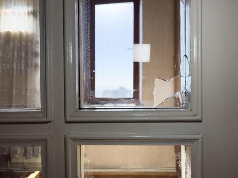 Broken window in the door, broken small window, crack on the window, broken window concept photo