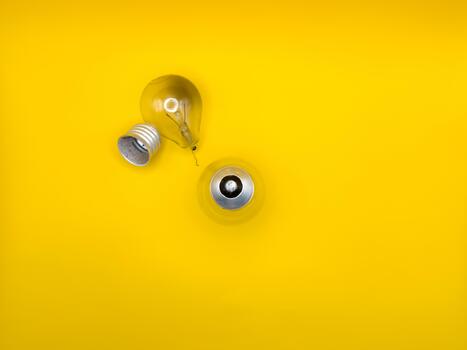 Tungsten light bulb lamp. Non-working light bulb, broken light bulb Concept, idea, electricity copy space, flay lay, top view yellow background. photo