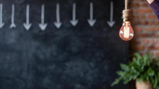 Creative light bulb with chalkboard arrows pointing down for ideas and innovation photo