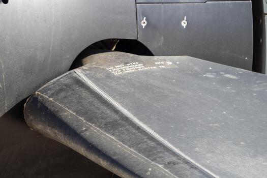 Detailed macro view of a turboprop propeller blade highlighting its curvature, composite texture, and aerodynamic surface under daylight photo