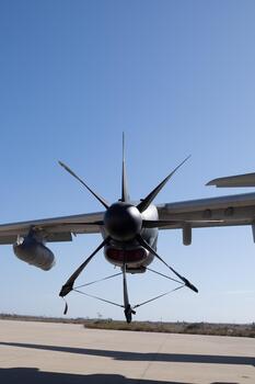 Detailed view of turboprop engine nacelle and multiple propeller blades with static discharge wicks installed along the trailing edge photo