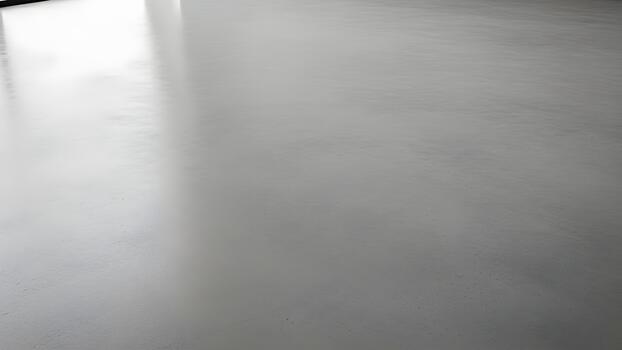 Light gray polished concrete floor with a subtle reflection from an unseen light source. photo