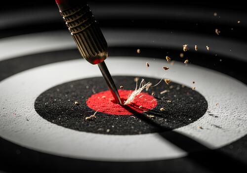 Close-up of a dart embedded in a dartboard bullseye. photo