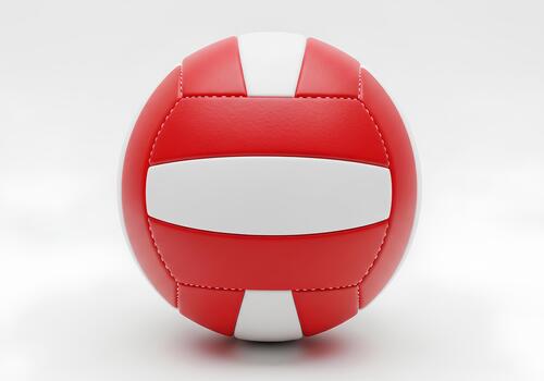A volleyball with a red and white pattern is shown. photo