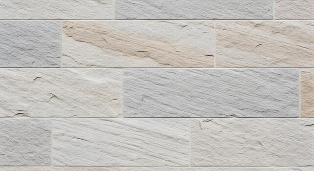Natural stone wall texture showing rectangular blocks. Subtle light grey and beige tones create a versatile background for architectural design photo